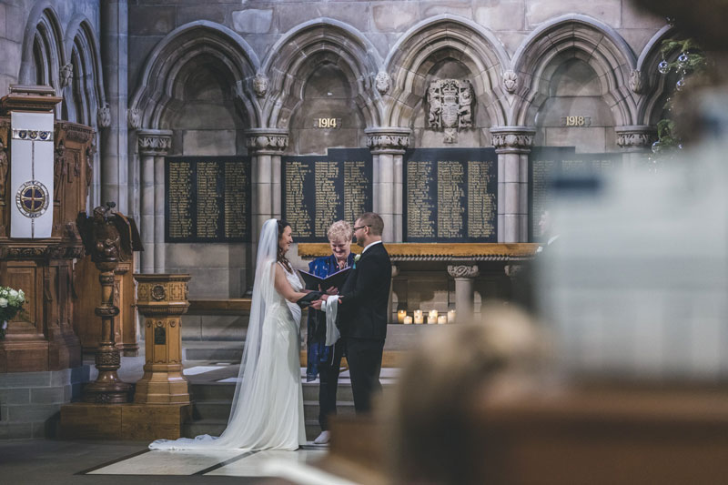 Philippa & Kristian hand in hand Maggie Kinloch wedding ceremony Glasgow University Memorial Chapel