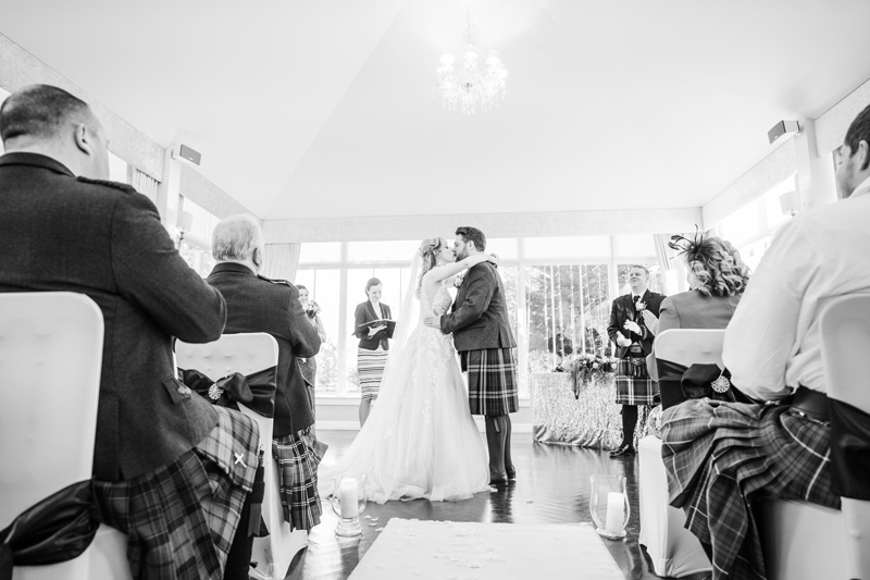 Bride and Groom first kiss after wedding ceremony Carlowrie Castle Edinburgh