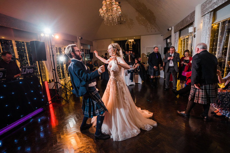 Bride and Groomsmen dance Carlowrie Castle wedding