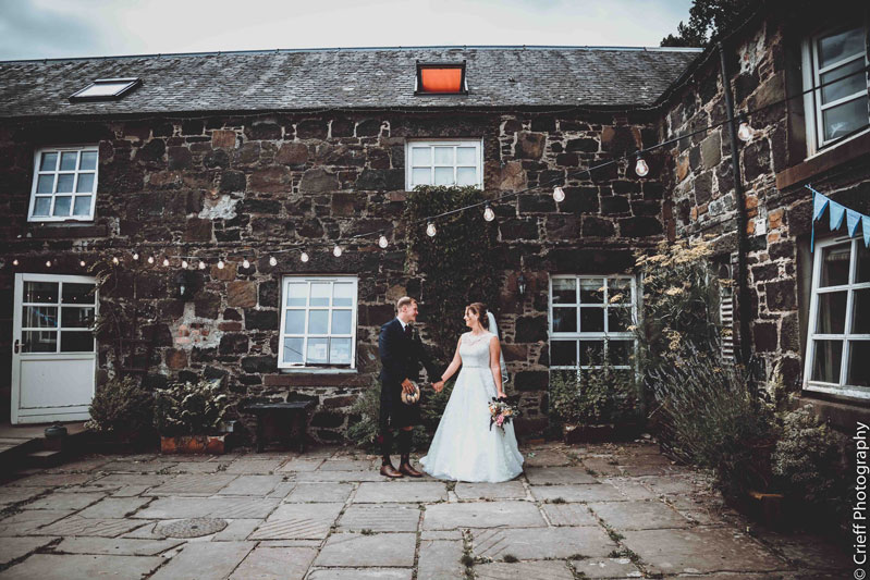 Nordic Courtyard Bride and Groom Outside Comrie Croft