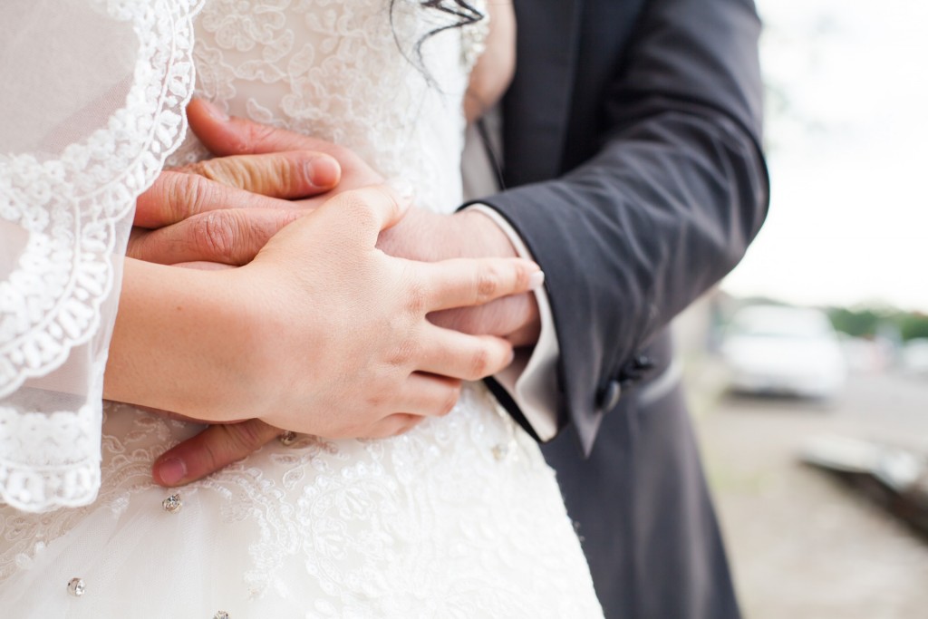 bride and groom holding hands and embrace