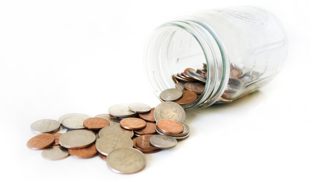 pennies spill out glass jar
