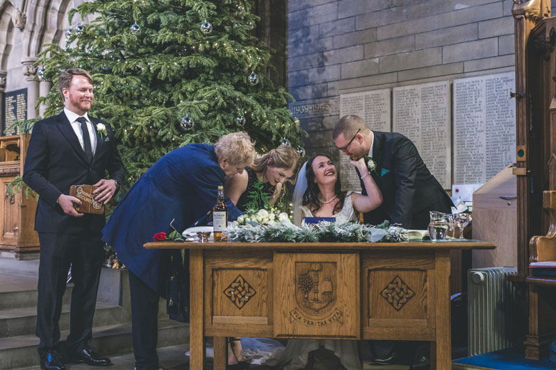 Philipa & Kristian sign marriage certificate with witness and Maggie Kinloch Glasgow University Memorial Chapel
