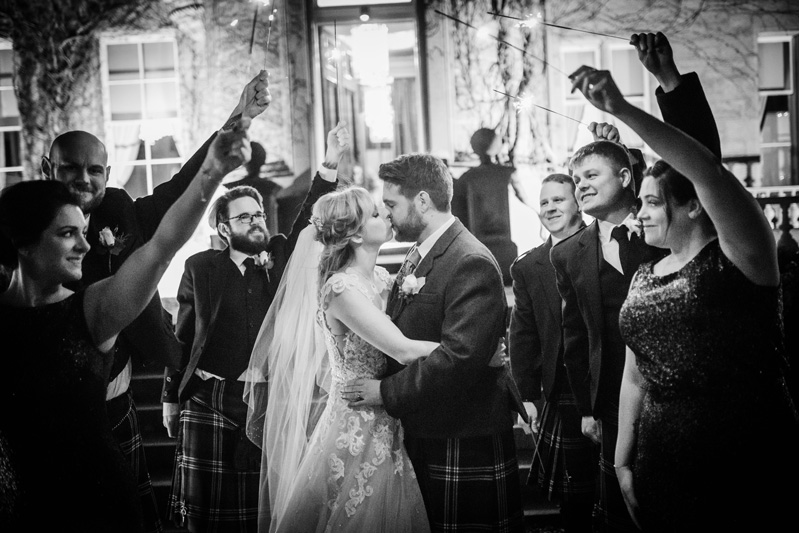 Bride and Groom kiss under sparklers outside Carlowrie Castle wedding