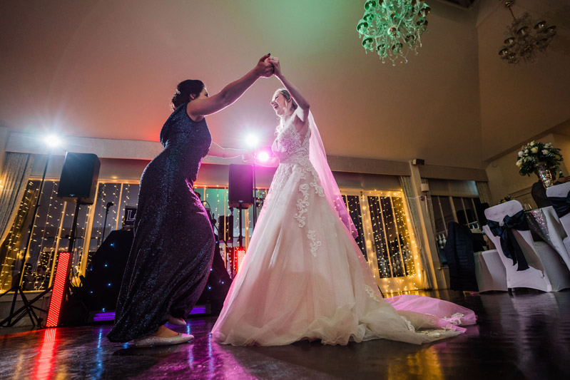 Bride and bridesmaid dance Carlowrie Castle