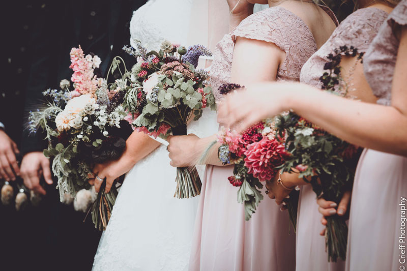 bride with bridesmaids and wedding flowers bouquets Comrie Croft